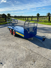 Twin axel flat trailer with bale racks